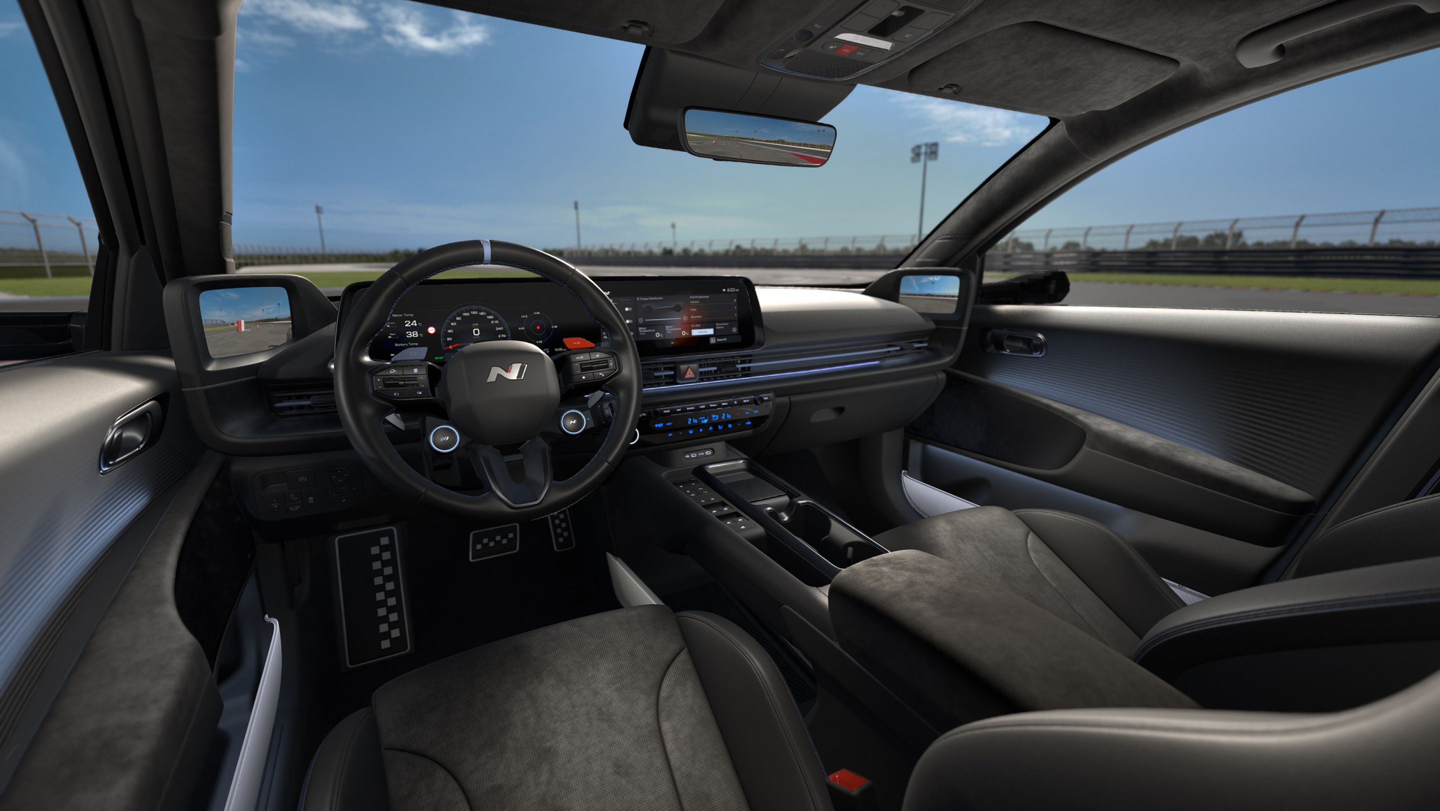 Interior view of Hyundai IONIQ 6N showing a driver-focused cockpit, dual displays and sporty seating on a race track.